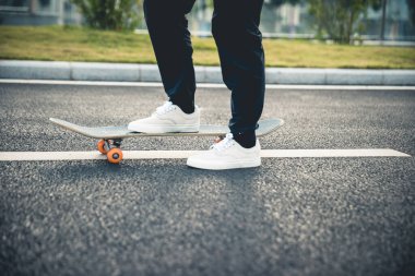 Kaykaycı şehir dışında kaykay yapıyor.