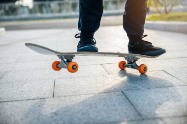 Kaykaycı şehir dışında kaykay yapıyor.