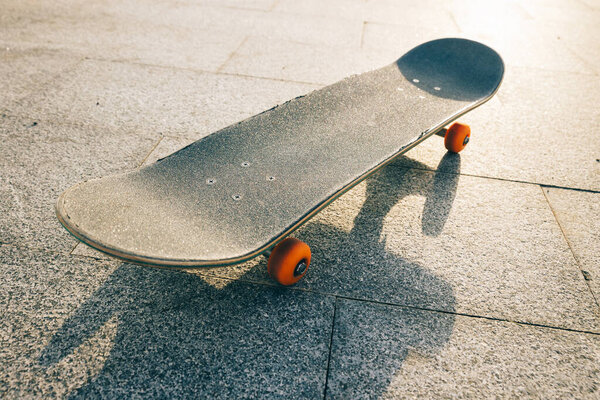 Skateboard outdoors in sunrise city