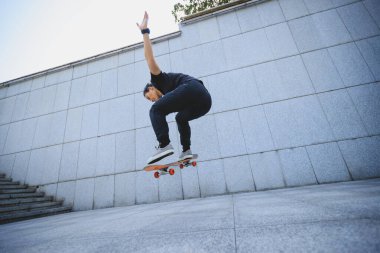 Modern şehirde Asyalı kaykaycı kadın.