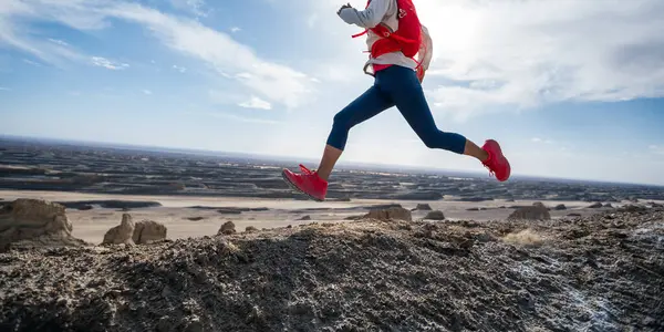 女赛跑选手在沙漠山顶跑步 — 图库照片
