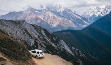 TIBET, ÇİN - 19 Mart 2022: Tibet, Çin 'deki yüksek irtifa dağlarında off-road araba sürmek