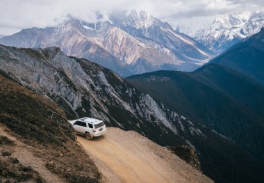 TIBET, ÇİN - 19 Mart 2022: Tibet, Çin 'deki yüksek irtifa dağlarında off-road araba sürmek