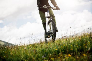 Çiçekli dağın tepesinde dağ bisikleti sürüyorum