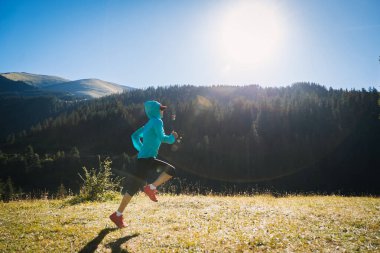 Fitness woman runner running in sunrise forest clipart