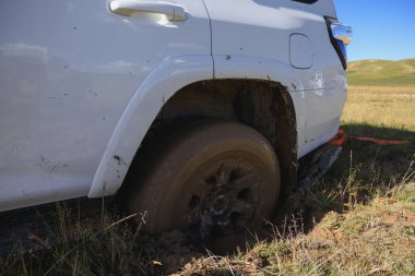 Offroad car got stuck in the mud clipart