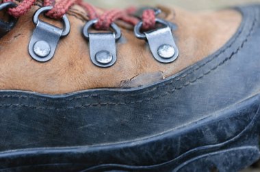 Leather hiking boots damanged by a tough trip clipart