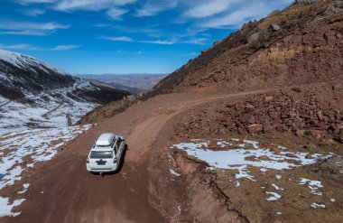 Driving off road car in high altitude mountains in tibet, China clipart