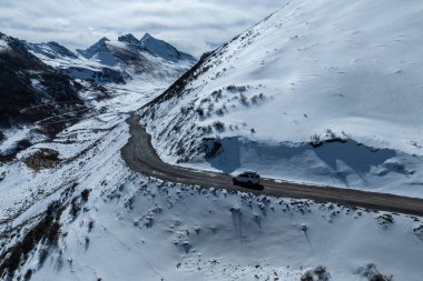 Driving off road car in high altitude mountains in tibet, China clipart