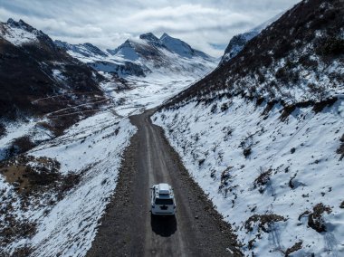 Driving off road car in high altitude mountains in tibet, China clipart