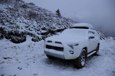 Driving car on high altitude mountain trail, China clipart