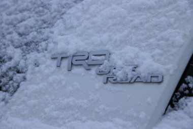 Tibet,China - November 04,2024,Toyota TRD OFFROAD with snow on modern white car  clipart