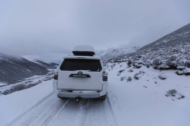 Sichuan ,China - Novermber 04 2024: Driving Toyota off road car 4runner  in high altitude mountains in Sichuan, China clipart