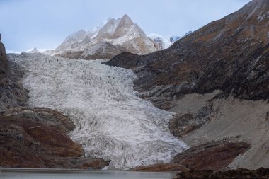 High altitude hanging glacier and snow capped mountain in Tibet, China clipart