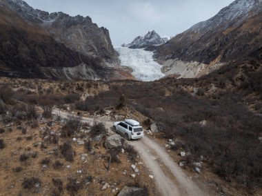 Tibet,China - November 23,2024: Driving off road car in high altitude mountains in tibet, China clipart