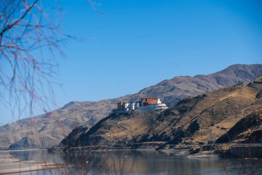 River and temple in Tibet, China clipart