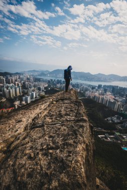 Kadın gezgin Hong Kong 'daki uçurumun kenarındaki manzaranın tadını çıkar.