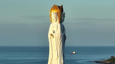 Guanyin heykeli Nanshan tapınağındaki sahil kenarında, Hainan Adası, Çin. Kelimelerin anlamı merhamet ve lütuftur.
