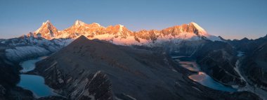 panoramic view over the vast, snow-covered mountains with lakes 