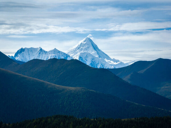 Gonggar Mountain. Beautiful foggy high altitude mountain landscape in China 