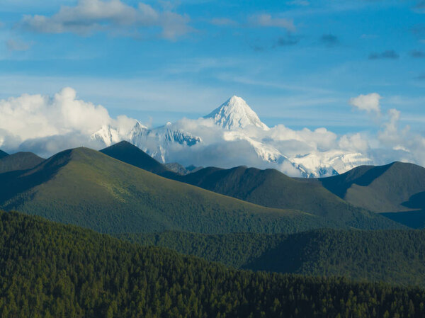 Gonggar Mountain. Beautiful foggy high altitude mountain landscape in China 