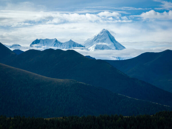 Gonggar Mountain. Beautiful foggy high altitude mountain landscape in China 