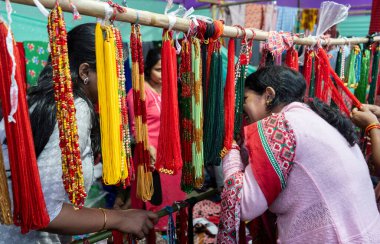 Nepali woman buys traditional beaded necklace at a stall, during North East Gurkha festival, on December 27, 2023 in Guwahati, Assam, India. Gorkha Development Council organised the North East Gurkha Festival to showcase the rich heritage of the Gork clipart