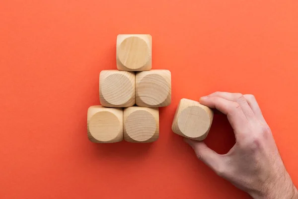 stock image Hand choosing a wooden block from a set. Business choice concept.