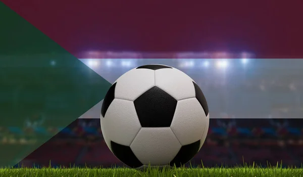 Soccer football ball on a grass pitch in front of stadium lights and sudan flag. 3D Rendering.