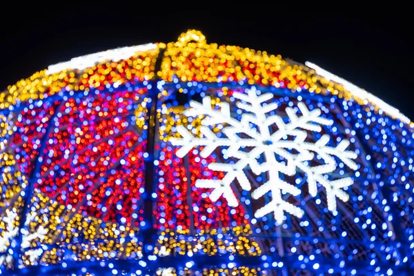 Abstract lights. Christmas street decoration lights, out of focus, blue, gold and red, with black background. Tenerife, Canary Islands, Spain.