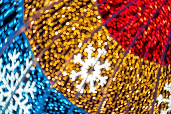 Abstract lights. Christmas street decoration lights, out of focus, in the shape of circles.  Blue, gold and red lights, with black background. Tenerife, Canary Islands, Spain.