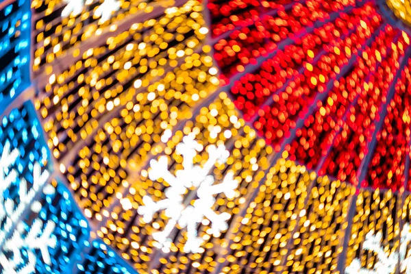 Abstract lights. Christmas street decoration lights, out of focus, in the shape of circles.  Blue, gold and red lights, with black background. Tenerife, Canary Islands, Spain.