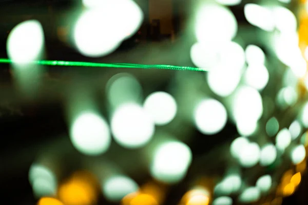 Abstract lights. Christmas lights out of focus in yellow, green colors with black background. Tenerife, Canary Islands, Spain.
