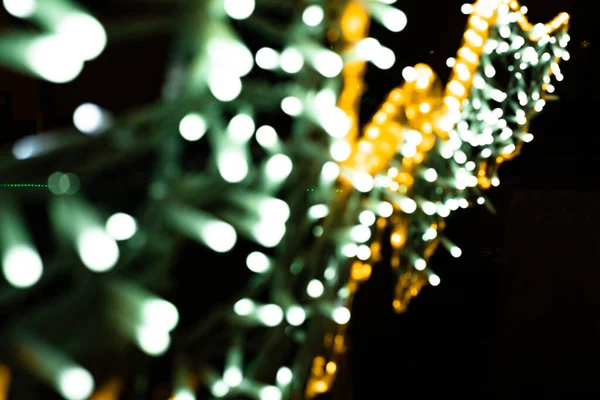 Abstract lights. Christmas lights out of focus in yellow, green colors with black background. Tenerife, Canary Islands, Spain.
