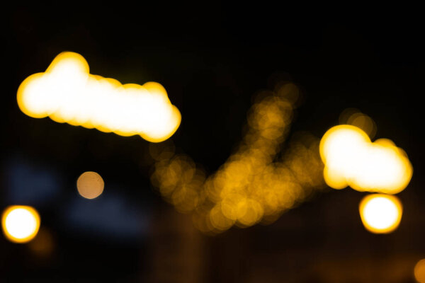 Abstract lights. golden flashes of Christmas lights out of focus, with black background. Tenerife, Canary Islands, Spain.