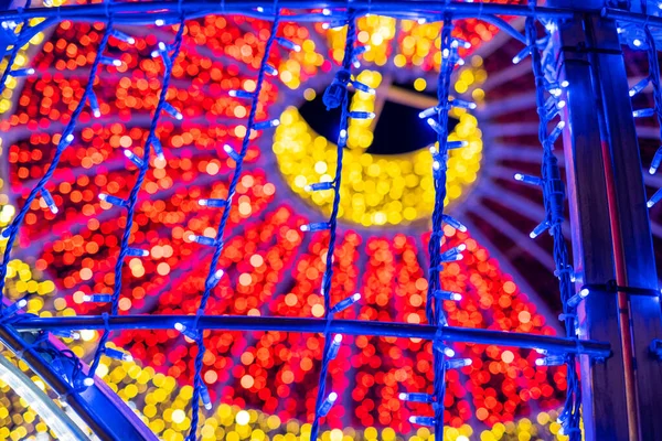 Abstract lights. Christmas street decoration lights, out of focus, in the shape of circles.  Red and gold and blue lights. With black background. Tenerife, Canary Islands, Spain.