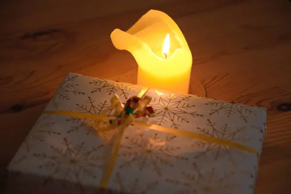 romantic candlelight and Christmas present in Christmas paper - presents