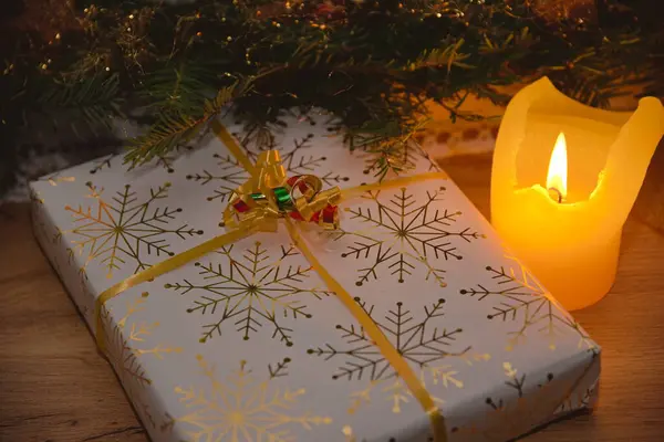 Gift giving with romantic candlelight and a Christmas present