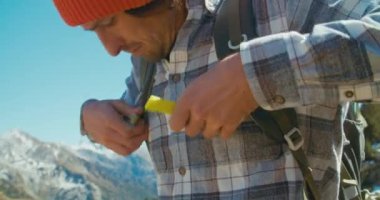 Young traveler man putts tourist backpack and start walking on mountain adventure. 