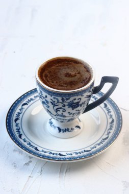 Beyaz arka planda mavi bardakta Türk kahvesi