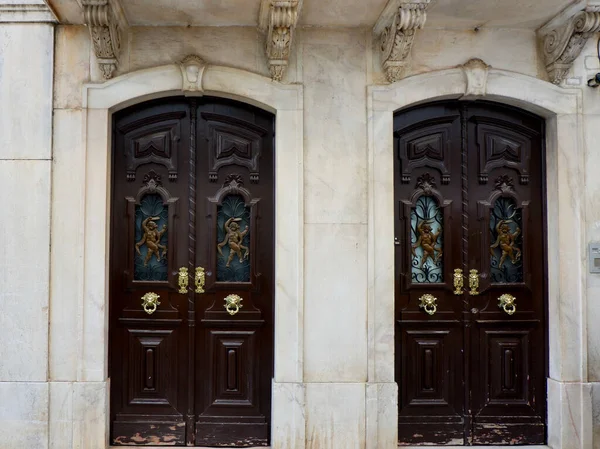 stock image Two vintage double doors decorated with classy art deco ornate outside on the street of Elvas, Portugal.