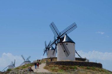 Campo de Criptana, Toledo, Spain - June 12, 2021: authentic windmills under the blue sky in the popular weekend trip destination