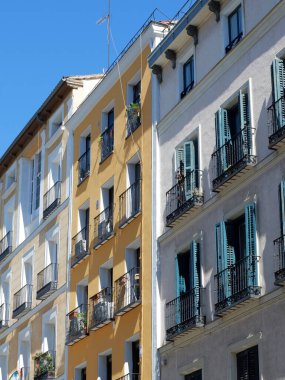 Old buildings of faded colours in Tirso de Molina, central district of Madrid, Spain. Vertoical photo.