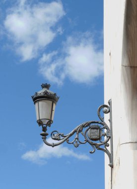 Vintage authentic street lantern downtown in Lavapies district, Madrid, Spain. Vertical photo.