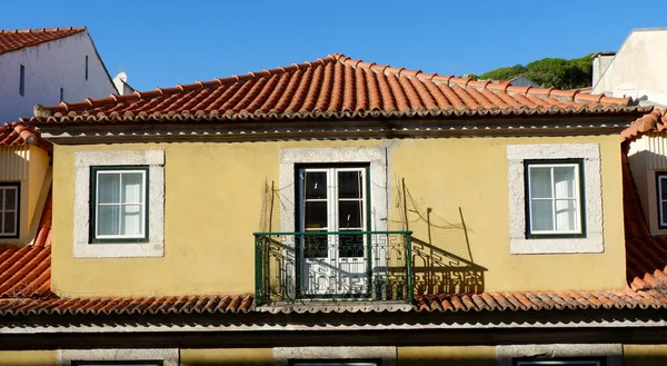 stock image Vintage classical building with tiled roof, windows and balcony. Roof top view.