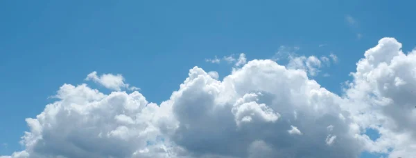 stock image Panoramic view of the top of volumetric cloudscape in the cyan blue sky.