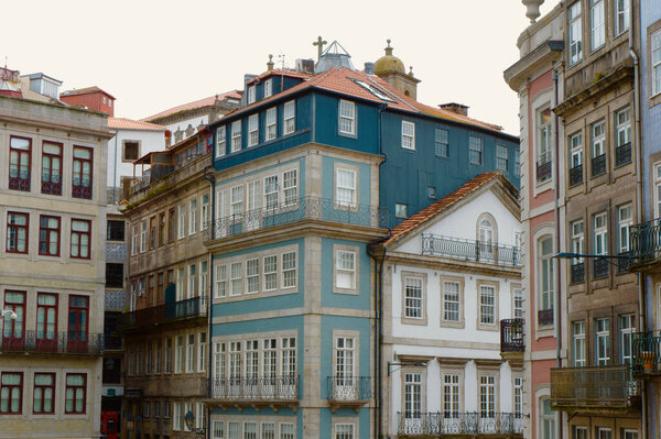 Elegant nostalgic buildings of different faded colours downtown Porto, Portugal.