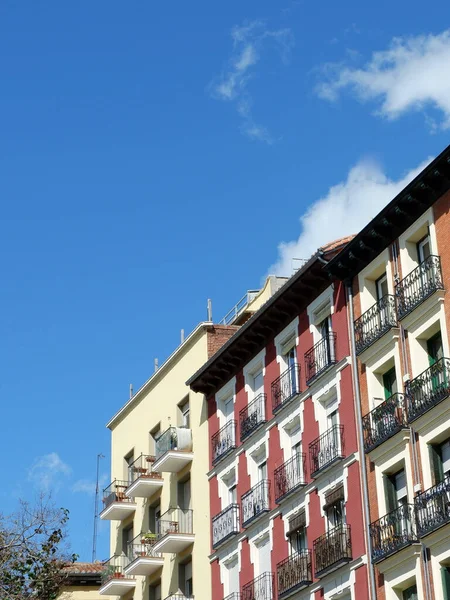 スペイン マドリード州ラバピーの伝統的な地区にある古い住宅の異なる鮮やかな色の改装されたファサード垂直写真 — ストック写真