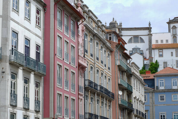 Traditional historic facades painted in different colours downtown in Porto, Portugal. Vintage architecture. Old fashioned living.