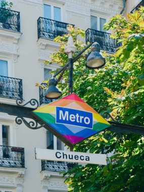 Metro sign in gay friendly district of Chueca, downtown, Madrid, Spain. clipart